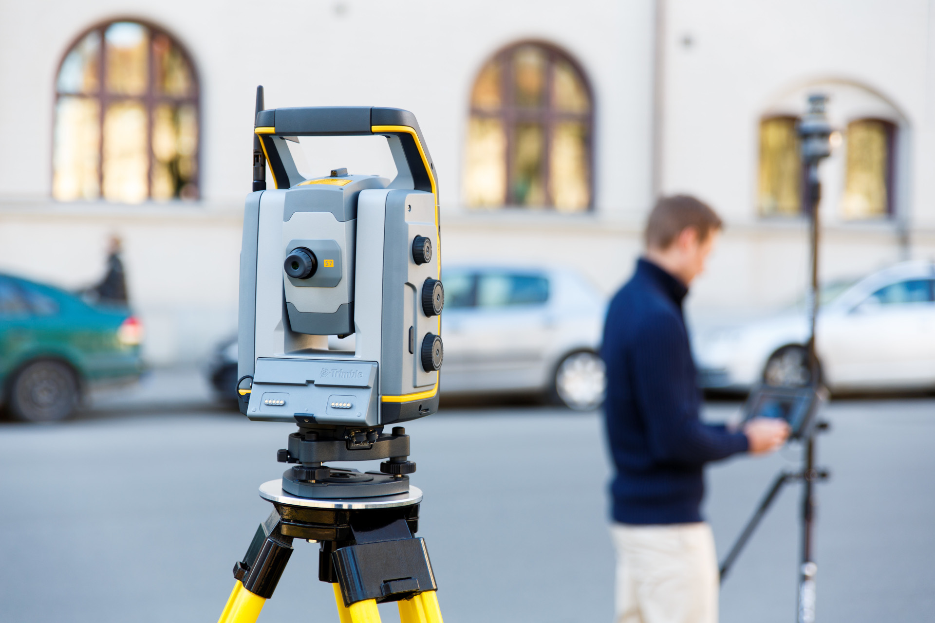 Decorative image of a surveyor and their equipment